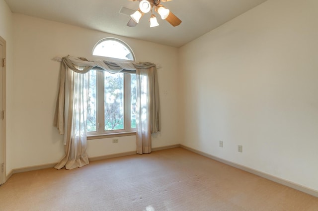 unfurnished room with ceiling fan, light colored carpet, and a healthy amount of sunlight