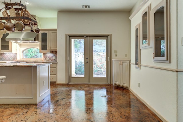 entryway with concrete floors and french doors