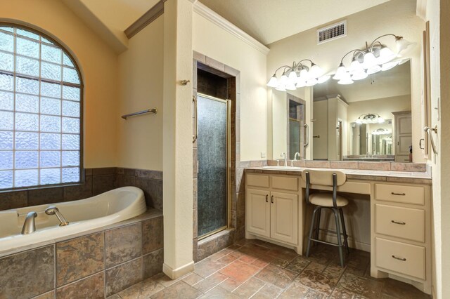 bathroom featuring independent shower and bath, vanity, and a wealth of natural light