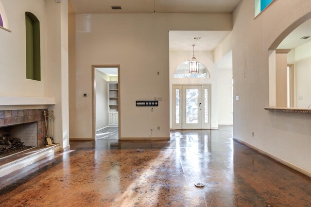 foyer featuring a high ceiling and a tile fireplace