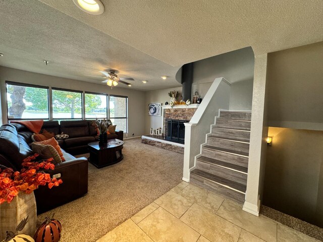 carpeted living room featuring a textured ceiling and ceiling fan