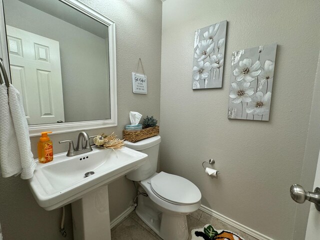 bathroom with tile patterned floors and toilet