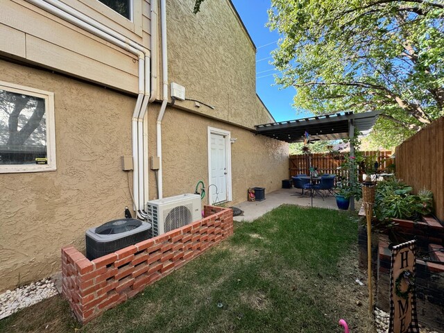 view of yard featuring ac unit, a patio area, and central AC