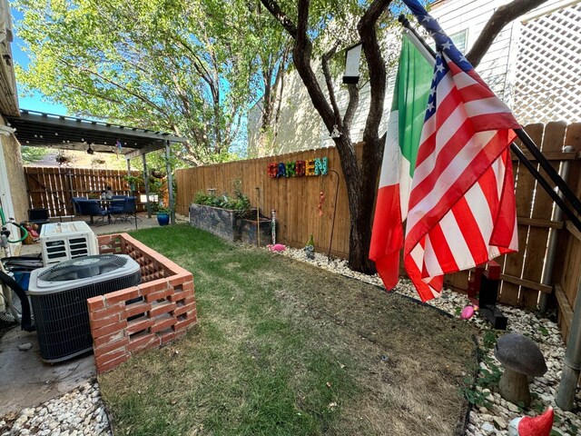 view of yard with central AC and a patio