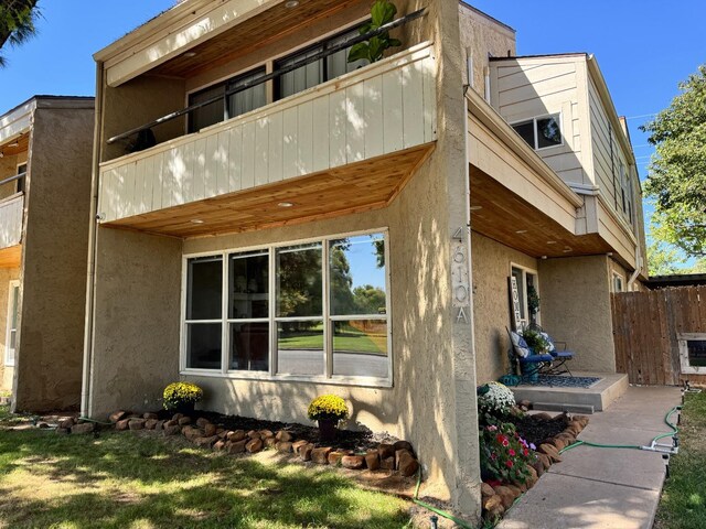 view of side of home with a balcony