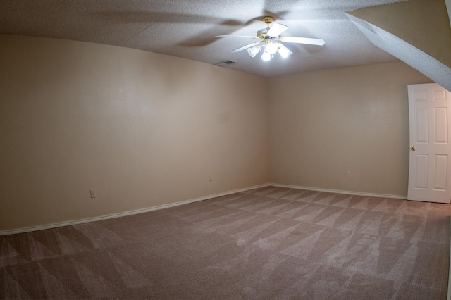 spare room featuring carpet and a textured ceiling