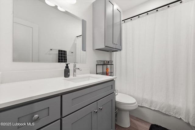 1203 N Evanston Ave, Lubbock, TX 79416 - bathroom featuring vanity, wood finished floors, and shower / bath combination with curtain
