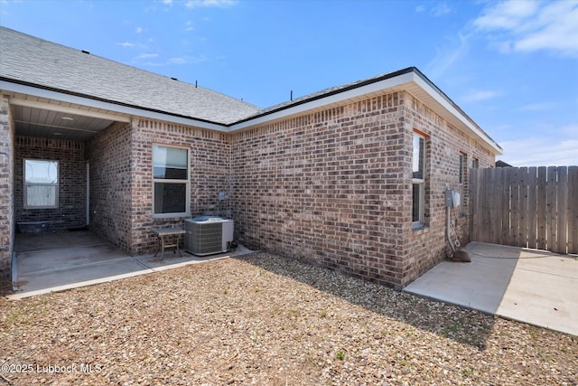 1203 N Evanston Ave, Lubbock, TX 79416 - view of side of property featuring a patio area and brick siding