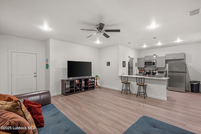 1203 N Evanston Ave, Lubbock, TX 79416 - living area with light wood finished floors, a ceiling fan, and recessed lighting