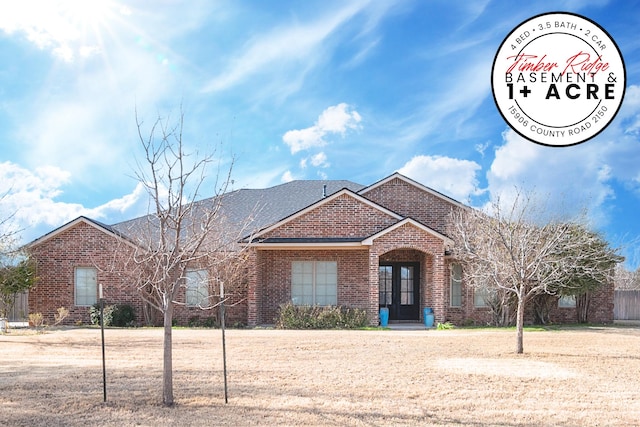 single story home featuring brick siding