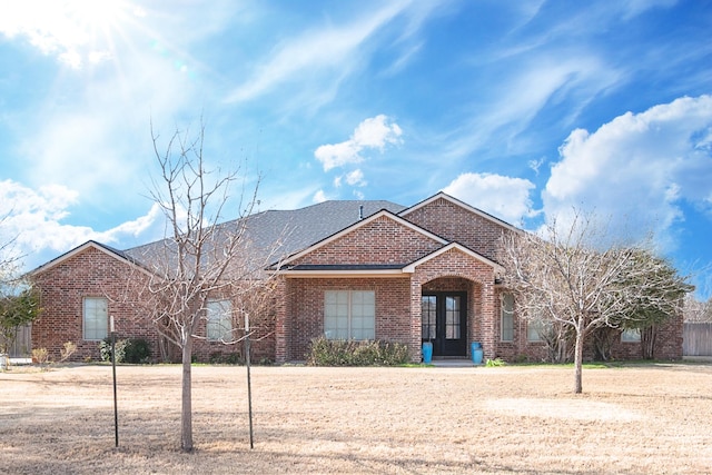 ranch-style home featuring brick siding