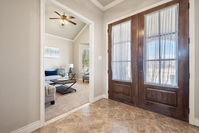 entrance foyer featuring crown molding, lofted ceiling, light colored carpet, and french doors