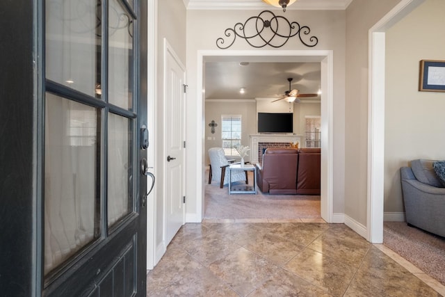 foyer entrance with light carpet, a fireplace, and ornamental molding