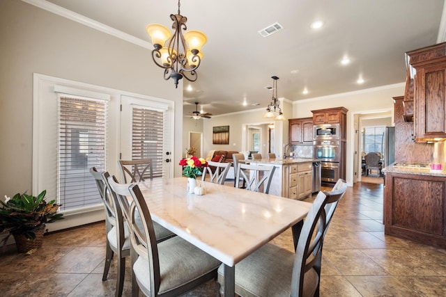 dining area with visible vents, recessed lighting, ornamental molding, dark tile patterned floors, and ceiling fan with notable chandelier