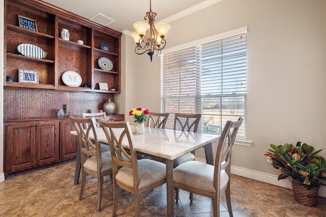 dining room featuring a chandelier, visible vents, crown molding, and baseboards