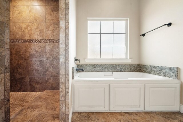 bathroom with a garden tub and walk in shower