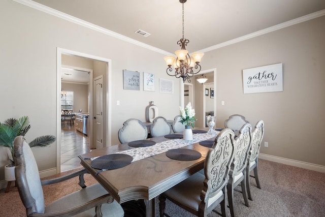 dining room with visible vents, a notable chandelier, ornamental molding, baseboards, and light colored carpet