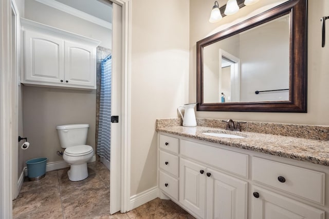 bathroom featuring vanity, curtained shower, toilet, and baseboards