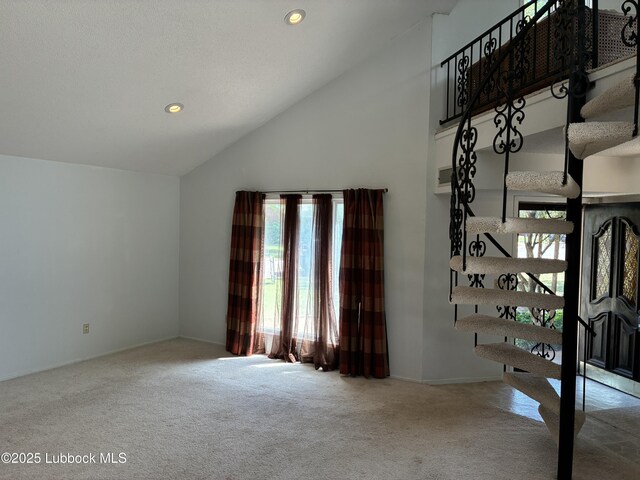 1423 Cherry Blossom Dr, Littlefield, TX 79339 - unfurnished living room featuring carpet floors, stairs, recessed lighting, and high vaulted ceiling