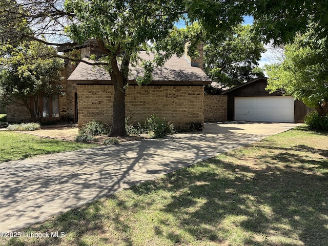 1423 Cherry Blossom Dr, Littlefield, TX 79339 - view of front of home with driveway, an outdoor structure, brick siding, and a front yard