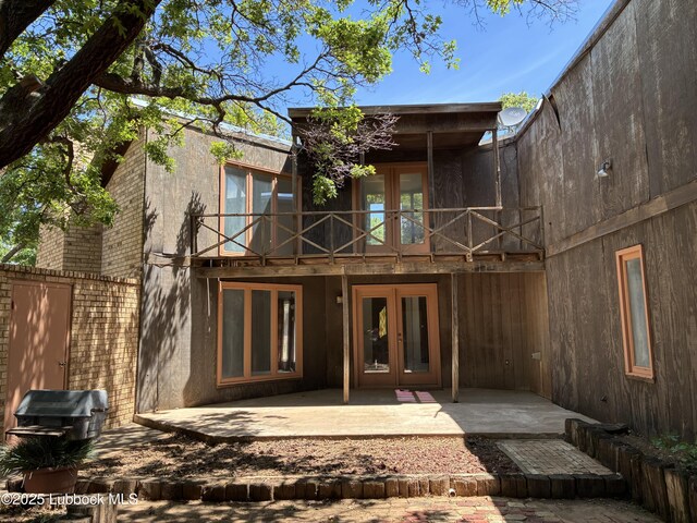 1423 Cherry Blossom Dr, Littlefield, TX 79339 - back of property featuring french doors, a balcony, and a patio area