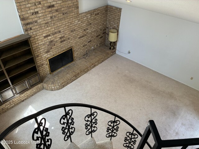 1423 Cherry Blossom Dr, Littlefield, TX 79339 - unfurnished living room featuring carpet flooring and a fireplace