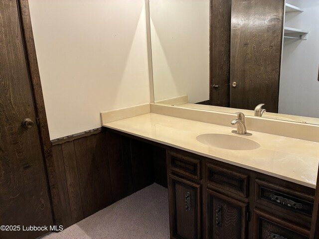 1423 Cherry Blossom Dr, Littlefield, TX 79339 - bathroom with vanity, a wainscoted wall, and wooden walls