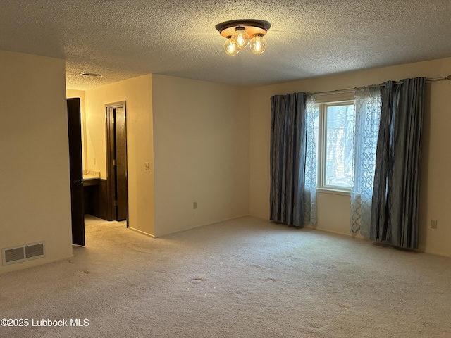 1423 Cherry Blossom Dr, Littlefield, TX 79339 - unfurnished room featuring light colored carpet and a textured ceiling