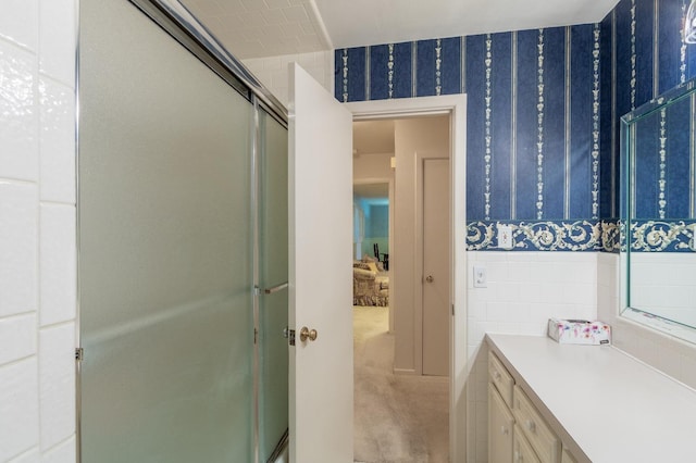 bathroom with walk in shower and vanity