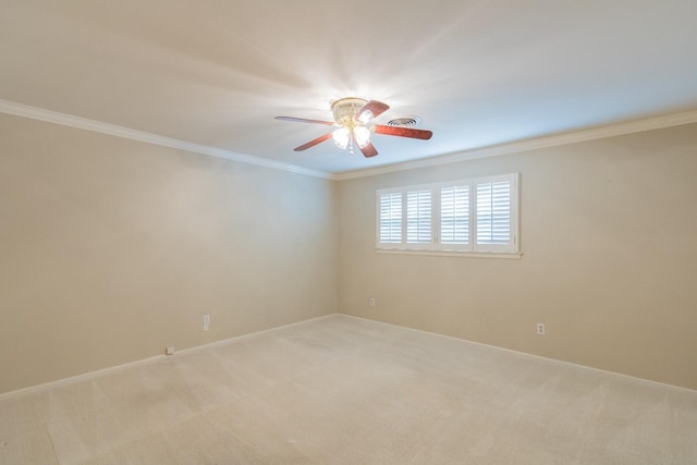 carpeted spare room featuring ceiling fan and ornamental molding