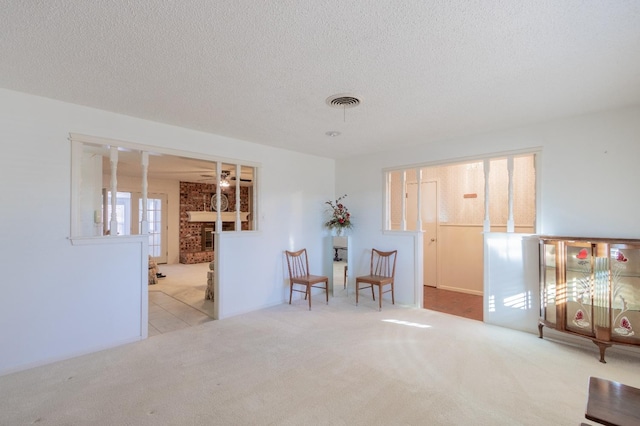 unfurnished room with light carpet and a textured ceiling