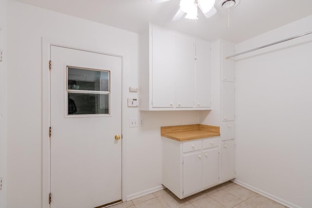 washroom featuring light tile patterned floors and ceiling fan