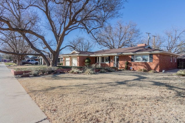 ranch-style home with a garage and a front yard