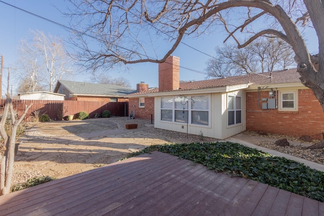 back of property featuring a wooden deck