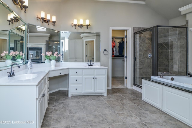 5901 102nd St, Lubbock, TX 79424 - bathroom with vaulted ceiling, double vanity, a stall shower, a bath, and a walk in closet
