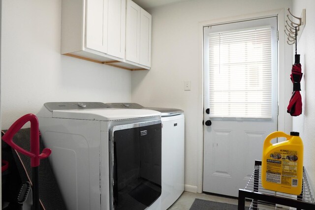 washroom with cabinets and separate washer and dryer