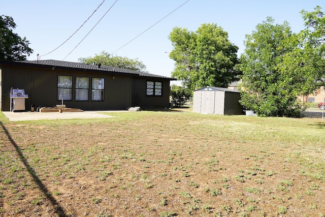 view of yard with a shed and a patio area