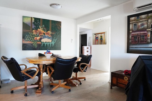 dining area with wood-type flooring and a wall mounted AC