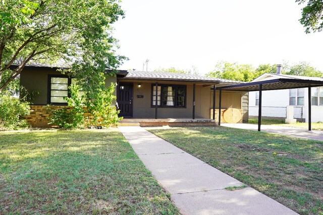 ranch-style house with a carport and a front yard