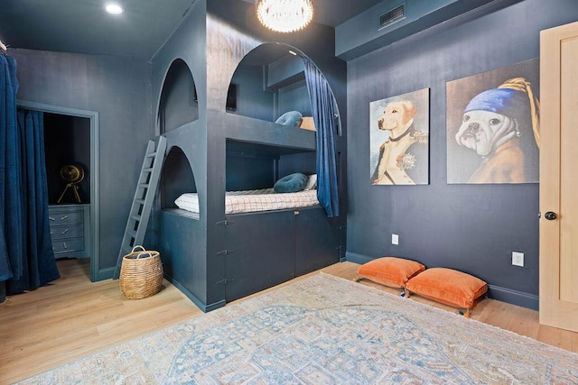 bedroom with visible vents and wood finished floors