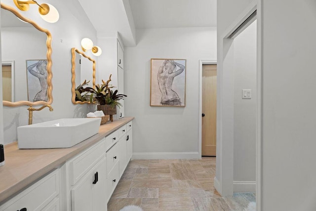 bathroom with baseboards and vanity