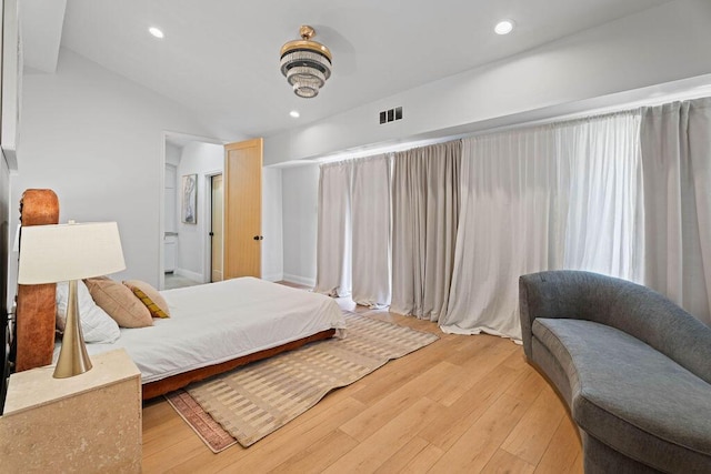 bedroom with visible vents, light wood-style flooring, recessed lighting, and vaulted ceiling