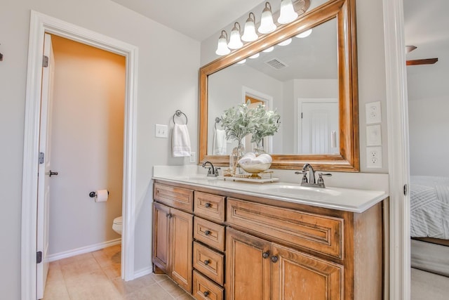 bathroom featuring tile patterned flooring, vanity, and toilet