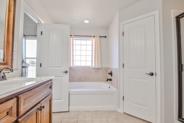 bathroom with vanity, tile patterned floors, and a bathing tub