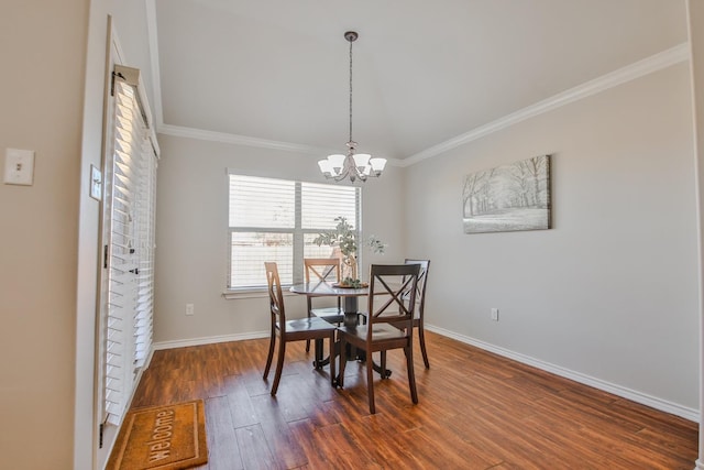 dining space featuring crown molding, dark hardwood / wood-style floors, and a chandelier