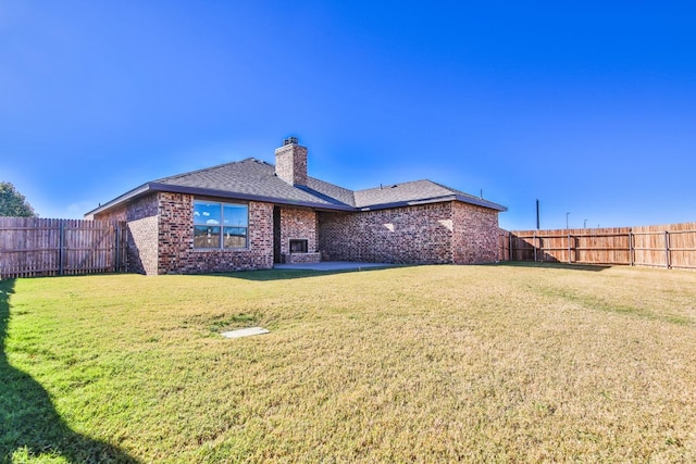 back of house featuring a lawn and a patio area