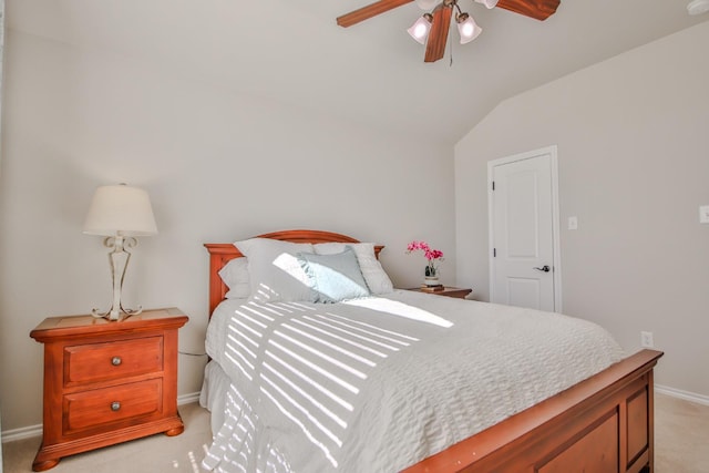 bedroom featuring light carpet, lofted ceiling, and ceiling fan