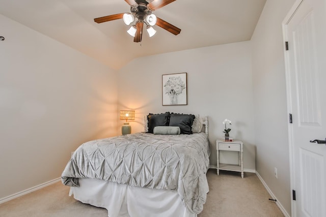 carpeted bedroom with ceiling fan and vaulted ceiling