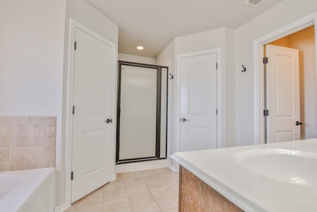 bathroom with sink, independent shower and bath, and tile patterned flooring