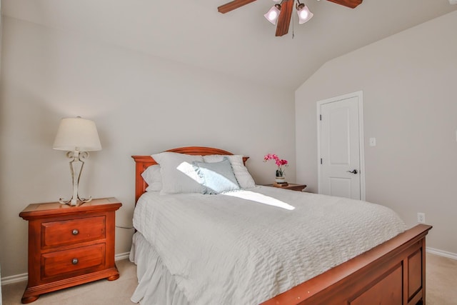 bedroom featuring lofted ceiling, light colored carpet, and ceiling fan